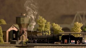 clip-1060482271-model-steam-locomotive-carries-freight-miniature-railway