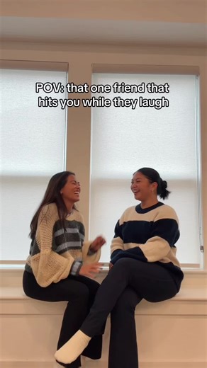 Filipino Friends Laughing and Playfully Slapping Each Other
