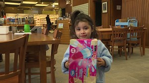 These kids are using cereal boxes and tape to get a safe look at the solar eclipse