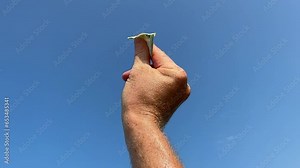 Euro note as paper airplane. 100 euros Banknote in form of paper plane. Money of European Union Euro note in hand on blue sky background. Concept of economy and banking. Euro Fall or rise of currency