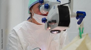 Two Female Surgeons Perform Eye Surgery with a Microscope and Medical Instruments. Professional Ophthalmologist Performs Cataract Surgery and Diopter Correction Using Modern Technologies. Slow Motion Stock Video