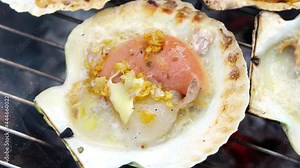 Grilled scallops shell with butter and garlic, Grilled scallops on a hot charcoal stove.