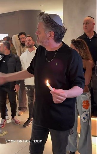 Amir dadon lighting the chanuka menorah
