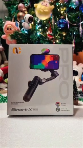 Najmeh. Lab on Instagram‎: "Revolutionary Portable Gimbal Designed to elevate your smartphone videography to professional levels This palm-sized gimbal features an OLED display that not only displays gimbal modes but also a battery indicator, setting it apart from standard smartphone gimbals. This gimbal is capable of illuminating you with three adjustable brightness levels. Its powerful brushless motors offer greater stability than other gimbals and enable smooth, continuous video recording. Th