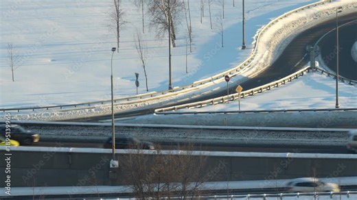 Winter highway interchange with empty roads and snow, symbolizing transportation infrastructure, logistics, mobility, and modern urban planning