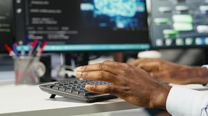 Data center computer scientist at desk using AI deep learning algorithms to analyze datasets. Server room IT specialist typing on PC keyboard, using artificial intelligence neural networks, camera B
