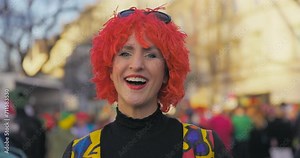Carnival - Cheerful costumed woman making a kissy face and then laughing. Handheld shot. Slow-mo.