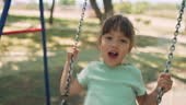 Little Girls Playing At Playground Outdoors In Summer
