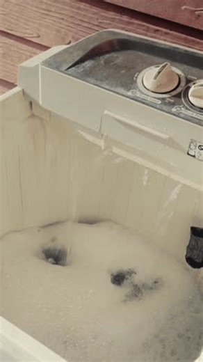 clip-4003356677-close-up-top-loading-washing-machine-filling-water