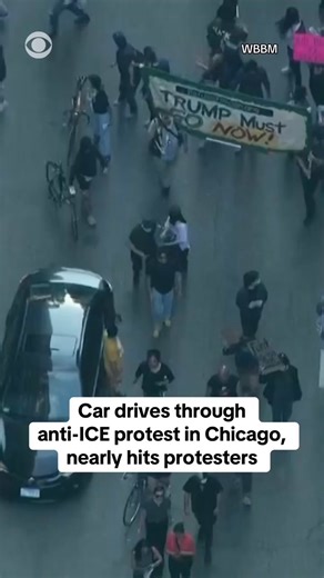 A car drove through an anti-ICE protest in downtown Chicago on Tuesday, nearly hitting the protesters who were marching. A witness told CBS Chicago that the vehicle came close to slamming into people, saying it was a "miracle that nobody got hit." The driver was seen speeding away after passing the protesters. https://cbsn.ws/3HzIGjO | CBS News