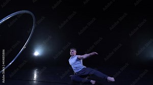 Circus artist dancing with cyr wheel. concept of concentration, willpower, and movement