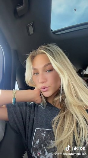 Blonde Individual Enjoys a Drive in a Sunny Car