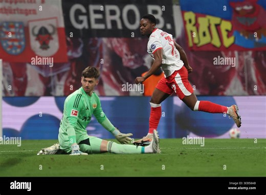 Leipzig, Germany. 24th Apr, 2026. Soccer, Men: Bundesliga, RB Leipzig - 1. FC Union Berlin, Matchday 31, Red Bull Arena, Ridle Baku (r, RB Leipzig) celebrates next to goalkeeper Carl Klaus (1. FC Union Berlin) about the goal for 3:0. IMPORTANT NOTE: According to the regulations of the DFL German Football League and the DFB German Football Association, it is prohibited to use or have used photographs taken in the stadium and/or of the match in the form of sequential images and/or video-like photo