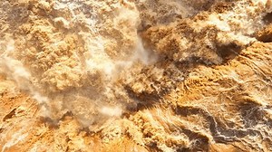 A waterfall flood, a natural disaster, can be monitored using a drone, which provides vital aerial data for assessment and response. Flash flood concept.