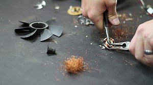 clip-5187179-man-scrapping-copper-computer-fan