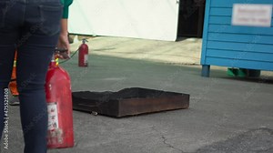 Man teaches or training how to use carbon dioxide (CO2) fire extinguishers to extinguish fires from fuel in house or industry for safety.