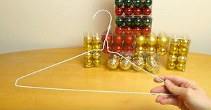 He Slips Ornaments Onto A Simple Wire Hanger To Create An Easy Christmas Wreath In A Snap