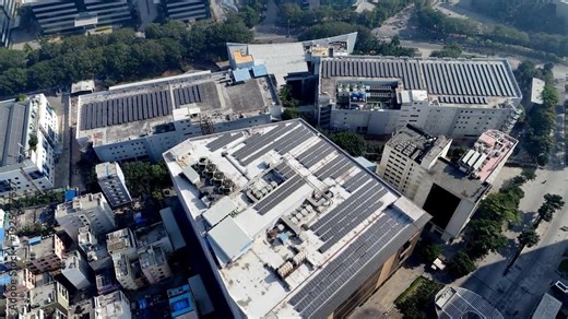 Aerial footage of Rooftops powered by the sun—expansive solar arrays transform this urban campus into a clean energy hub. Sustainable design in Hyderabad’s evolving skyline.