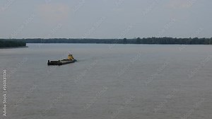 The great Siberian Ob river in middle reaches. On river floats propelled barge