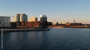 Calm low altitude left pan at outer Copenhagen harbour showing Sandkaj Nordhavn and UN city
