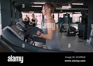 Side view of beautiful muscular woman running on treadmill. High quality photo Stock Video Footage - Alamy