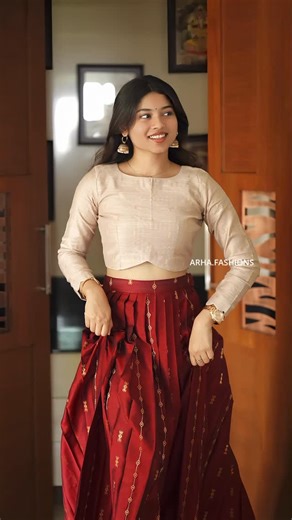 Arha Fashions | A365 - Top and pleated skirt combo featuring a soft beige blouse paired with a deep maroon skirt detailed with subtle gold zari detailing... | Instagram