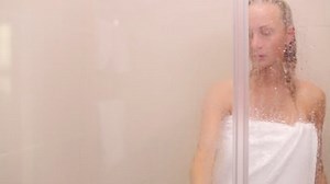 a woman comes out of the shower