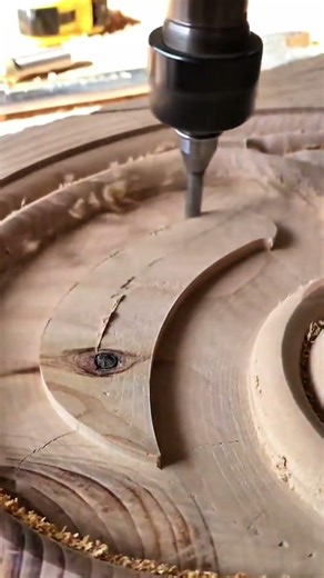 Carving intricate circular patterns into a solid wooden block using a high speed CNC router machine