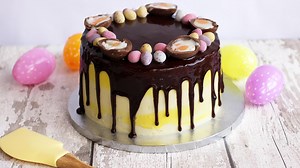 Celebrate Easter weekend with this fabulous drip cake! Simply heat and pour our new Mirror Glaze, and make sure to finish with lots of chocolatey Easter treats on top! Mirror Glaze is available in Morrisons and online at Sprinkles & Co! https://www.sprinklesandco.co.uk/shop/cake-decorations/cake-decor-mirror-glaze/ | Cake Décor