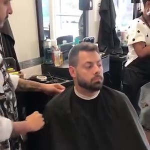 Barber etiquette 101. WAHL educator Miguel Rosas demonstrates how to properly put on a cape on your client. 1. You start in the front of the client and bring the cape towards them, not over their heads... 2. Don’t let the cape touch the clients skin. 3. You start in front of the clients and bring the cape towards them, not over their heads...half over the cape once it’s connected. | Wahl Professional USA