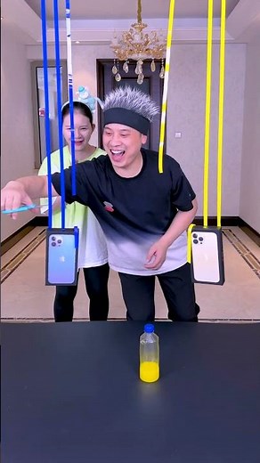 A Man And A Woman Stand On A Bottle And Compete To See Who Wins The Phone! #Funny
