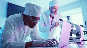 Researchers in a modern lab use advanced equipment to analyze chemicals, highlighting the intersection of science and technology.