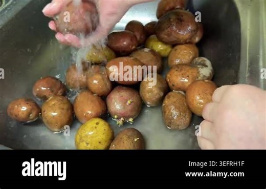 Washing organic red potatoes in the kitchen sink; close-up of hands peeling fresh raw vegetables for dinner Stock Video Footage - Alamy