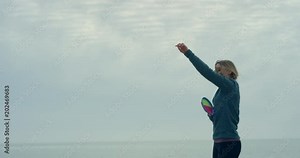 Young woman on beach throwing and catching ball Stock Video