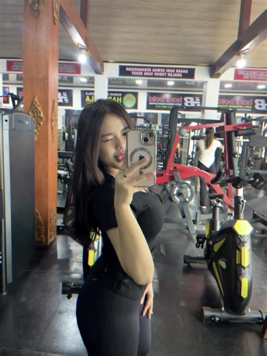 Creative Mirror Selfies in a Modern Gym Setting