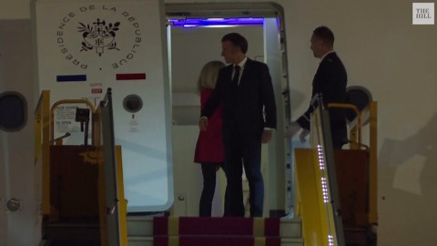France’s first lady seems to push her husband as they land in Vietnam. He says they were joking