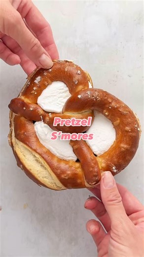 With only 3 ingredients, these pretzel s’mores take seconds to assemble and a few minutes in the oven until the marshmallow is gooey. They’re the perfect combo of sweet and salty - delicious!. I used a shop bought soft savoury pretzel, a giant marshmallow and a slab of chocolate. #smores #pretzelsmores #pretzels #easyrecipe #marshmallow #quickrecipe | The Fast Foodie