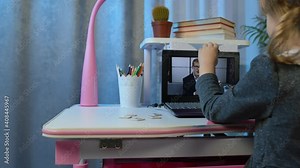 Preschool child girl distance online learning at home. Cute kid pupil watching video lessons studying using digital laptop computer. Children remote study homework education on covid-19 quarantine