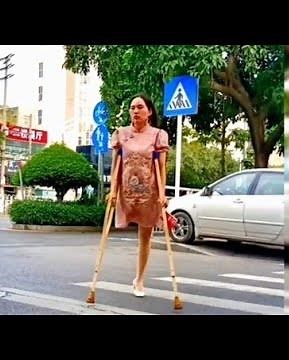 The beautiful woman is an amputee and lives with one leg, walking with wooden crutches #amplife