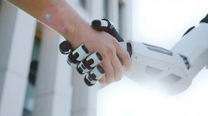 clip-1100297907-close-up-shot-unrecognizable-human-shaking-robot-hand