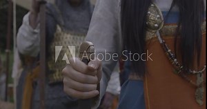 medieval female holds sword and stabs