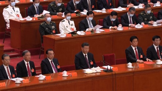 Former Chinese president Hu Jintao is unexpectedly led out of Saturday's closing ceremony of the Communist Party Congress. A staff member supports Hu by the arm as he stands up. He also speaks to President Xi Jinping for a moment and pats Premier Li Keqiang on the shoulder before being led out. | Radio Free Asia