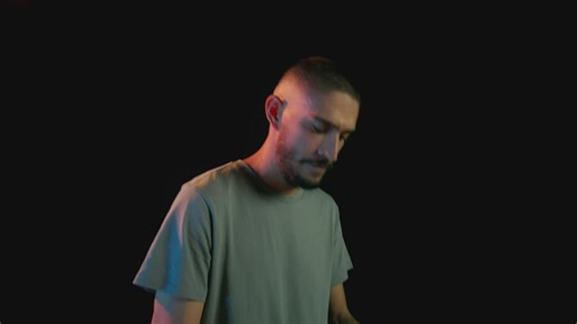 Musician playing the keyboard on a dark background - Free Stock Video