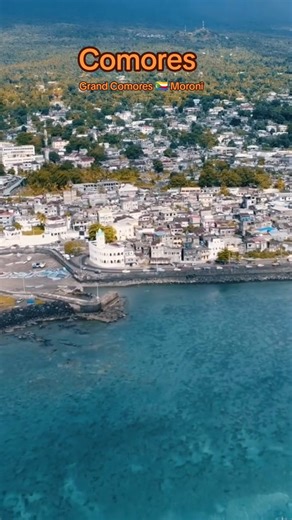 Moroni is the capital of Comoros and a city shaped by island life, steady movement, and strong community ties. You walk through narrow streets lined with old buildings, mosques, and local shops. The Indian Ocean sets the tone as waves and sea air reach many parts of the city. You hear the sound of daily activities from early morning. Markets stay active as people trade goods, greet friends, and prepare for the day. The mix of voices, movement, and colour gives the city a clear rhythm. Food plays