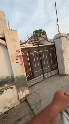 Paper boy delivers newspapers with precise throws while riding motorcycle in Jind, Haryana, India