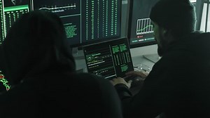 clip-1098486195-cyber-security-hacker-typing-on-laptop-coding