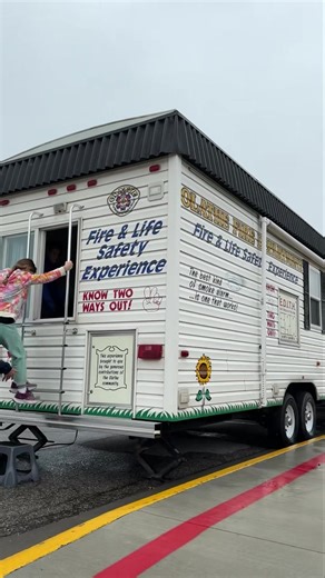 Practicing a safe - and slightly damp - escape with second-graders and the Fire Safety House. The FSH has rolled from school to school in Olathe since 2001. | City of Olathe Fire Department