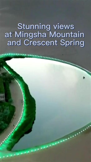 In Dunhuang, northwest China's Gansu Province, the Mingsha Mountain and Crescent Spring scenic spot is a striking natural wonder where desert dunes and a pristine water spring exist side by side. #Dunhuang #ChinaTravel | China Xinhua News