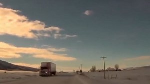 Semitruck rolls after sliding on black ice