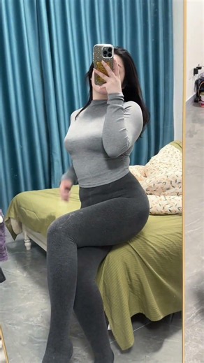 A beauty with a slightly curvy figure looks pleasantly soft and shapely in yoga pants.#beauty
